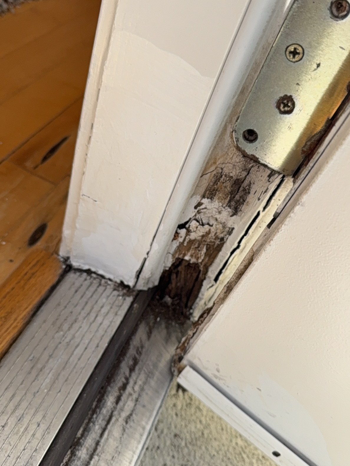 Significant water-intrusion rot at a balcony door jamb — found during a recent Bellevue townhouse inspection.