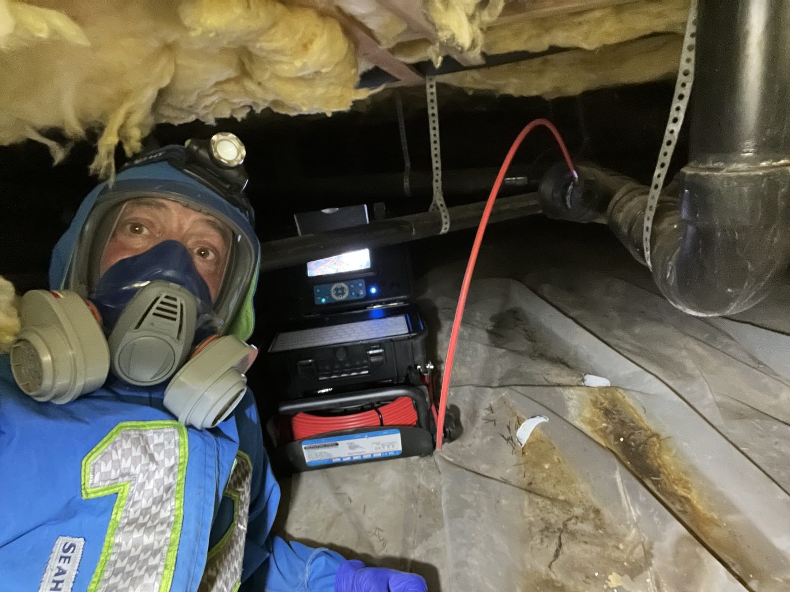 Bryan Mize conducting crawlspace inspection