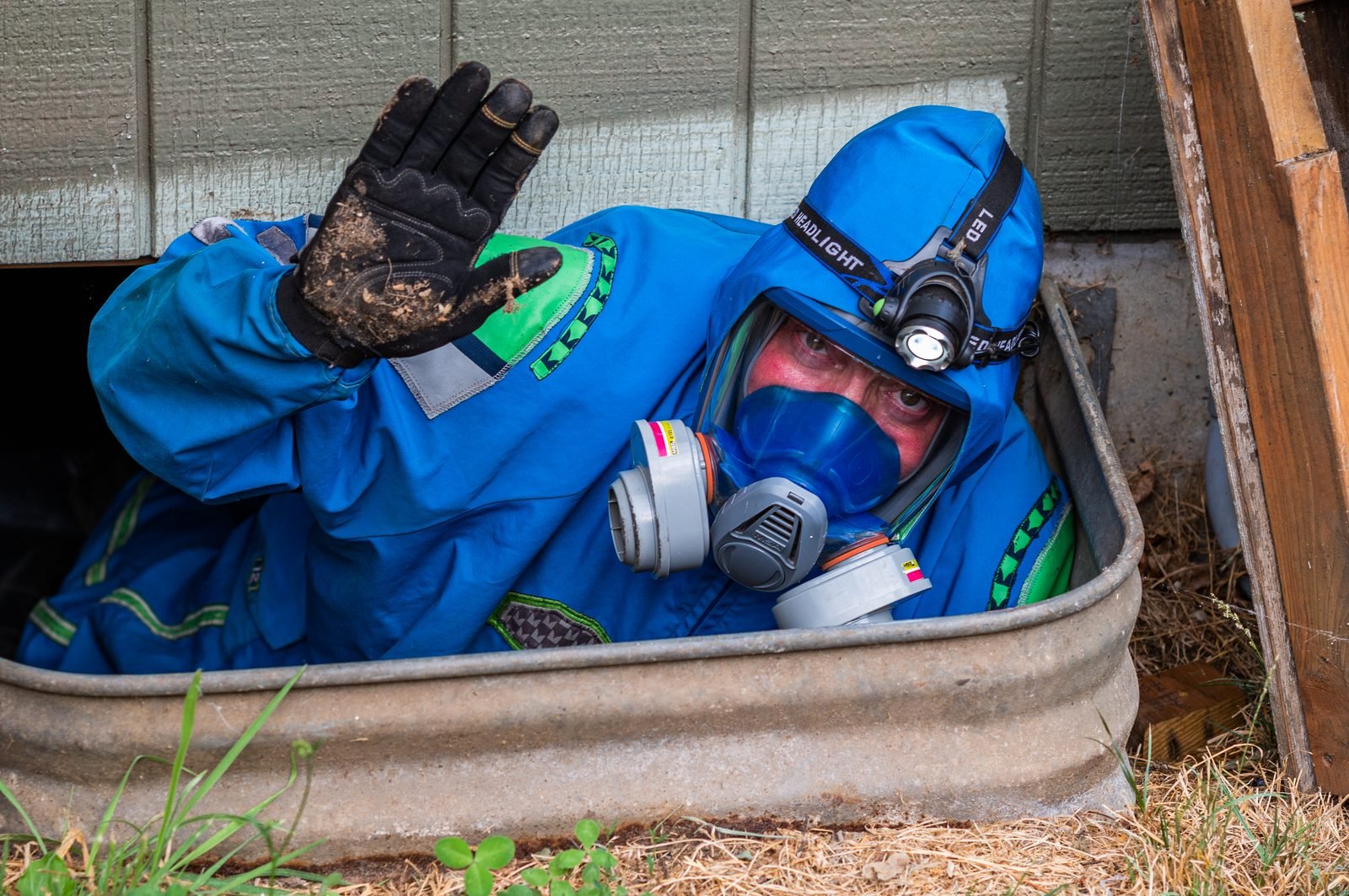 Bryan Mize entering a crawlspace for inspection