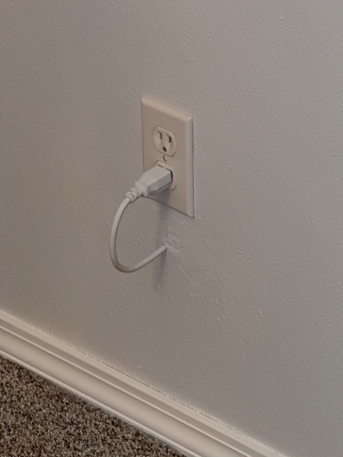 DIY electrical work — a power cord routed through a hole in the drywall in place of proper wiring, a fire-safety concern found during a recent Lynnwood inspection.
