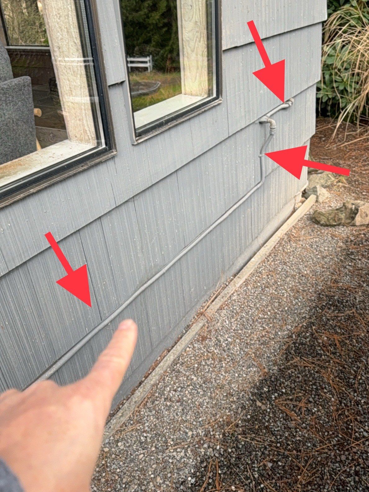CSST gas tubing exposed on exterior siding without its required protective jacket — a code-required protection found missing in a recent Redmond inspection.